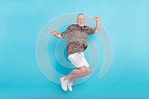 Full body photo of funky active happy old man jump up air good mood isolated on blue color background