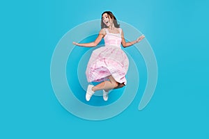 Full body photo of happy beautiful young woman jump look empty space fly skirt isolated on blue color background