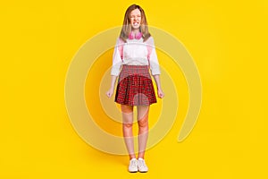 Full body photo of mad small girl wear headphones shirt skirt bag sneakers isolated on yellow background