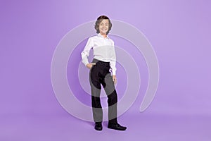 Full body photo of nice small brunet boy stand wear formalwear trousers isolated on purple color background