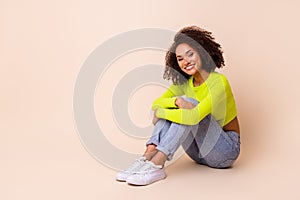 Full body photo of nice young girl wavy hair sit floor hug knees toothy smile wear trendy yellow outfit isolated on