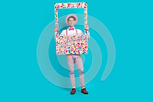 Full body photo of optimistic guy wear white shirt pink headwear bow tie holding frame make picture isolated on blue