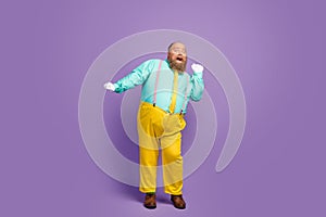 Full body photo of positive cheerful fat man enjoy dancing on discotheque wear turquoise shirt trousers white gloves