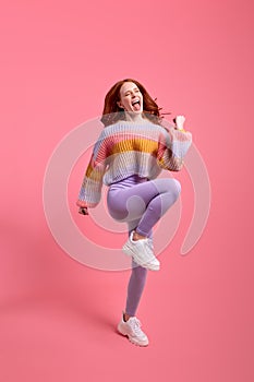 Full body photo of pretty funny redhead lady jumping high raising hands first