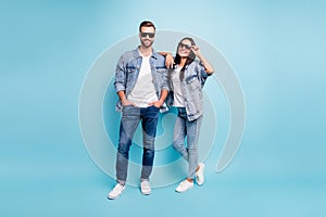 Full body photo of pretty man and woman with eyewear eyeglasses smiling wearing denim jeans jacket  over blue