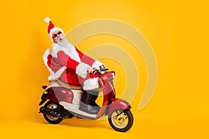 Full body photo of santa grandpa riding x-mas party by bike shocking moped speed wear stylish sun specs red coat