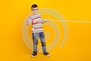 Full body photo of school kid have break free time playing tug war game with friends isolated on vivid color background