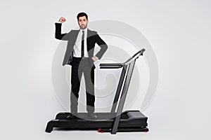 Full body photo of sportive classy person stand treadmill flexing biceps empty space advert isolated on grey color