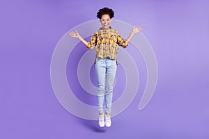 Full body photo of young african girl happy positive smile jumper wave hello isolated over purple color background