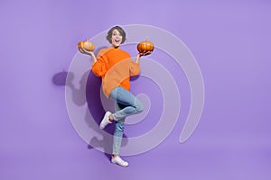 Full body photo of young cheerful girl good mood pick pumpkin store isolated over purple color background