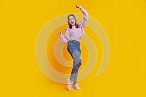 Full body photo of young cheerful girl rejoice victory fists ahnds lucky isolated over yellow color background