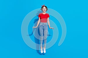 Full body photo of young cheerful lovely woman jumper fly dream travel isolated over blue color background