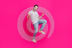Full body photo of young excited man good mood rejoice success fists hands isolated over magenta color background