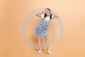 Full body photo of young friendly girl cover face v-signs peace symbol wear trendy blue sarafan model isolated on beige