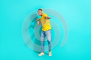 Full body photo of young guy enjoy his itunes playlist music wireless earphones dancing cool party isolated on