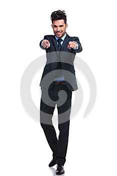 Full body picture of a business man pointing his fingers