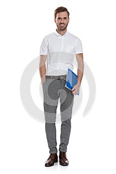 Full body picture of a casual man holding notepad
