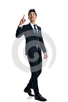 grateful elegant man pointing finger to the sky, looking up and thanking photo