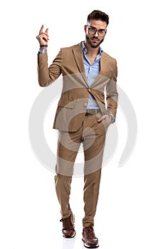 Full body picture of handsome businessman holding hand in pockets