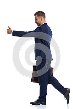 full body picture of unshaved businessman making thumbs up sign