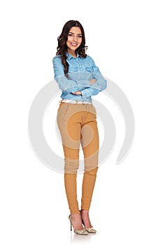 Full body picture of a woman standing with hands crossed photo
