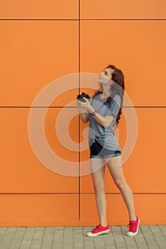 Full Body portrait of a beautiful girl with old film camera looking up