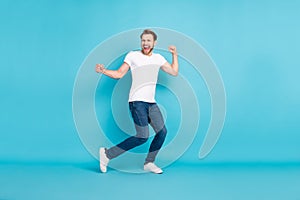 Full body portrait of cheerful excited young person raise hands fists open mouth smile isolated on blue color background