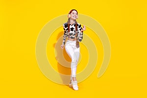 Full body portrait of cheerful satisfied lady dancing chilling listen new song isolated on yellow color background
