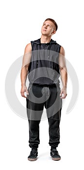 Full body portrait of handsome muscled young man looking up, isolated on white background