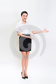 Full body portrait of happy smiling young beautiful business woman showing something or copyspase