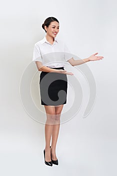 Full body portrait of happy smiling young beautiful business woman showing something or copyspase