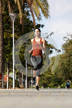 Healthy young woman running outdoors