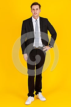 Full body portrait photo of handsome and executive look caucasian businessman in black suit pose in boss action and positive smile