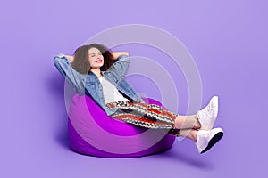 Full body portrait of pretty young woman chill beanbag wear denim shirt isolated on purple color background