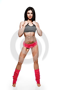 Full body portrait of slim attractive fitness female in pink sportswear