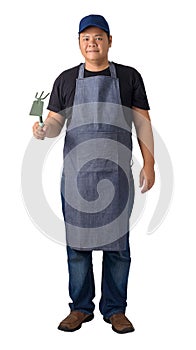 Full body portrait of a worker man or Serviceman in Black shirt and apron is holding Shovel for Cultivators isolated on white