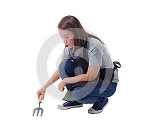 Full body portrait of a worker woman or Servicewoman in Gray shirt and apron. sitting and holding Shovel for Cultivators on white