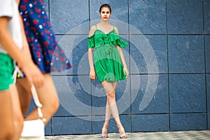 Full body portrait young beautiful brunette woman in green dress