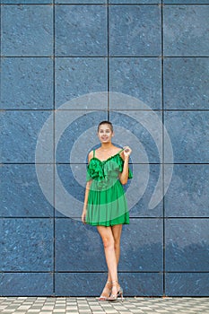 Full body portrait young beautiful brunette woman in green dress