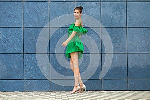 Full body portrait young beautiful brunette woman in green dress