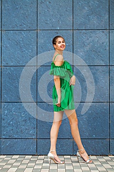 Full body portrait young beautiful brunette woman in green dress