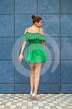 Full body portrait young beautiful brunette woman in green dress