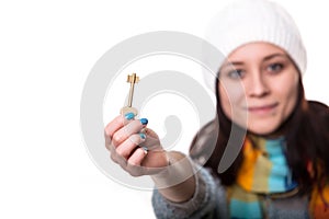 Full body portrait of young happy smiling business woman or real estate agent showing keys from new house, isolated on