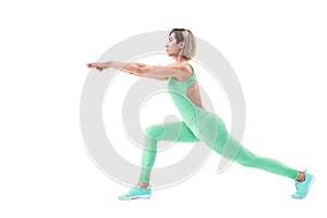 Full body portrait of young sporty woman stretching before exercise isolated on white background