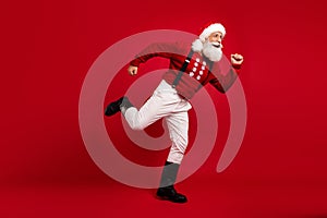 Full body profile side photo of cheerful santa happy positive smile run season sale shop christmas isolated over red