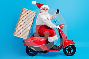 Full body profile side photo of white grey hair bearded santa claus drive motor bike travel x-mas christmas eve pile