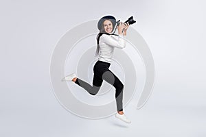 Full body profile side photo of young brunette jump up run hold camera job photographer  on grey color