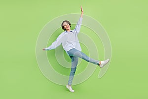 Full body profile side photo of young woman happy positive smile go walk playful isolated over green color background