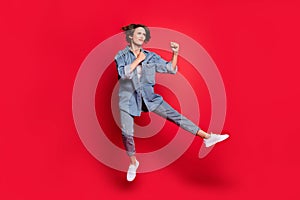 Full body profile side photo of young woman jump angry fighter kick karate look empty space isolated over red color