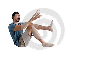 Full body of shocked Asian man being blown away on isolated background.